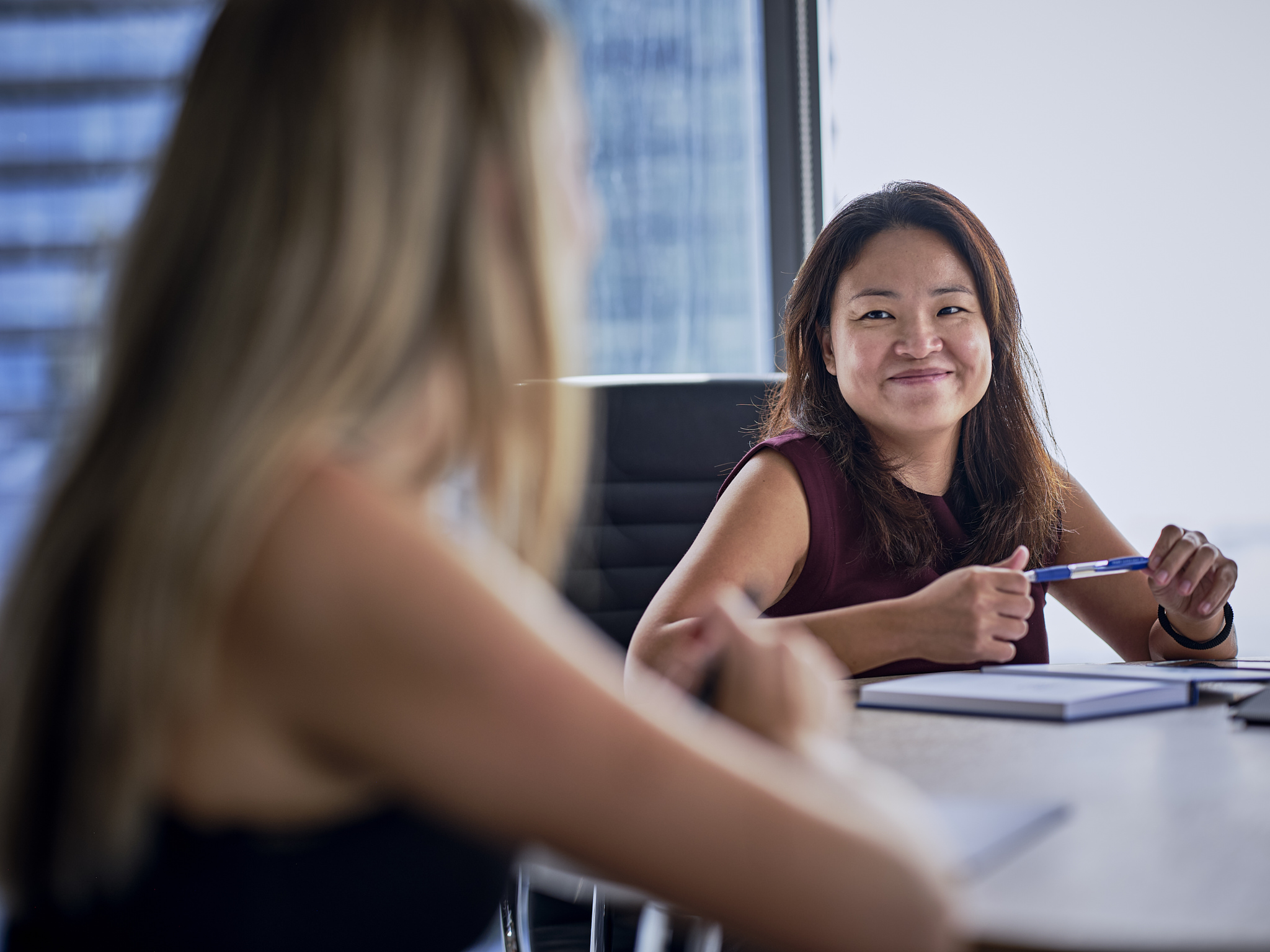 Two women engaged in conversation at a table.