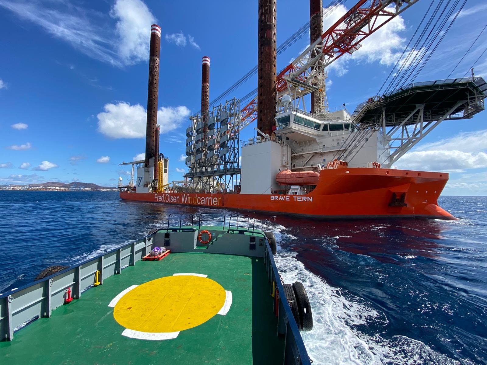 Offshore vessel alongside a wind turbine installation ship.