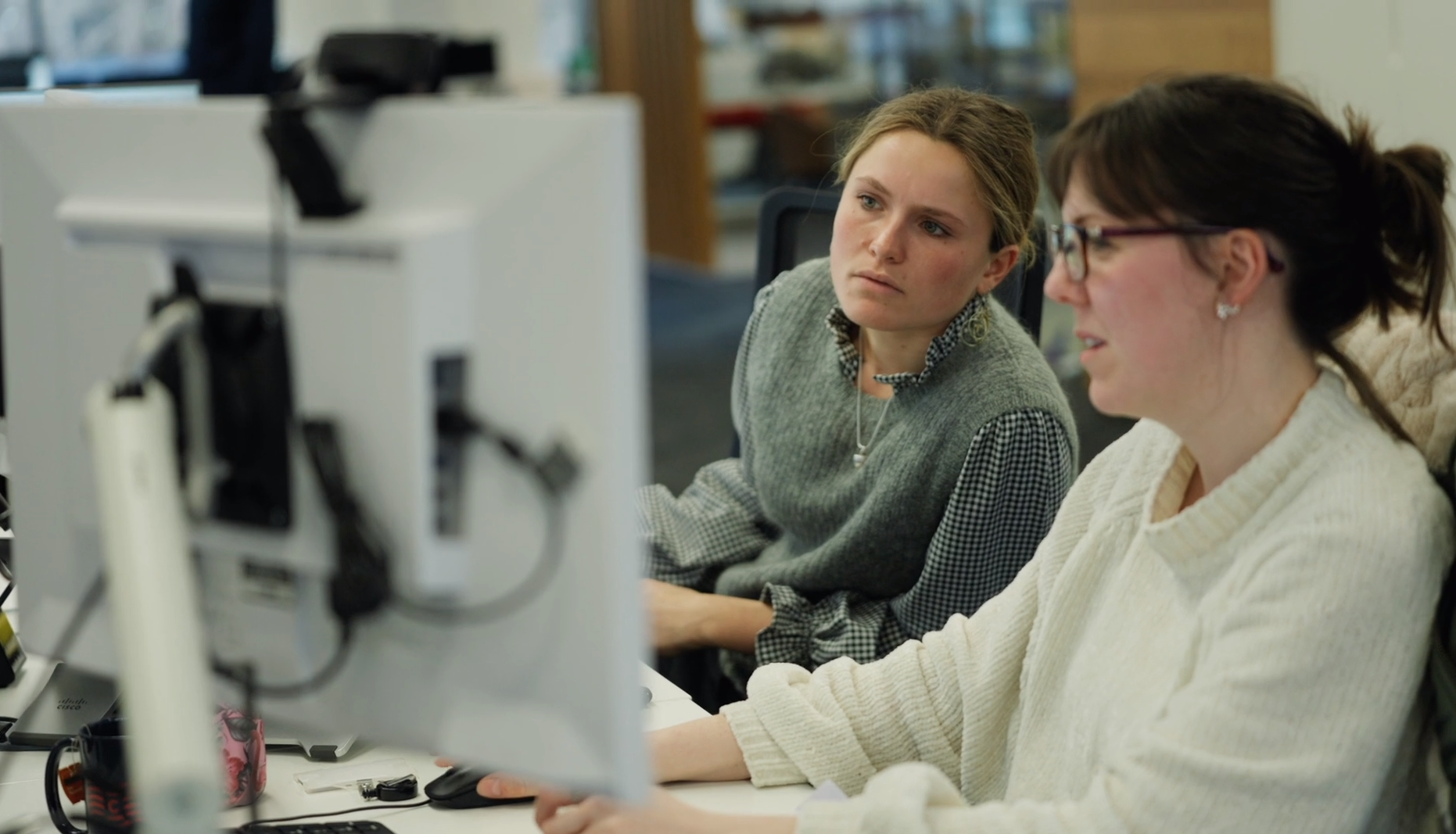 Two women collaborating at a computer.
