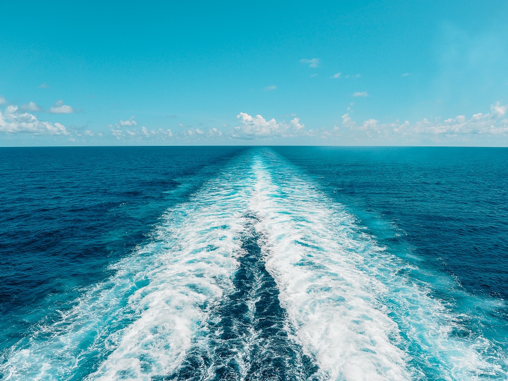 Calm ocean waves with a clear sky backdrop.
