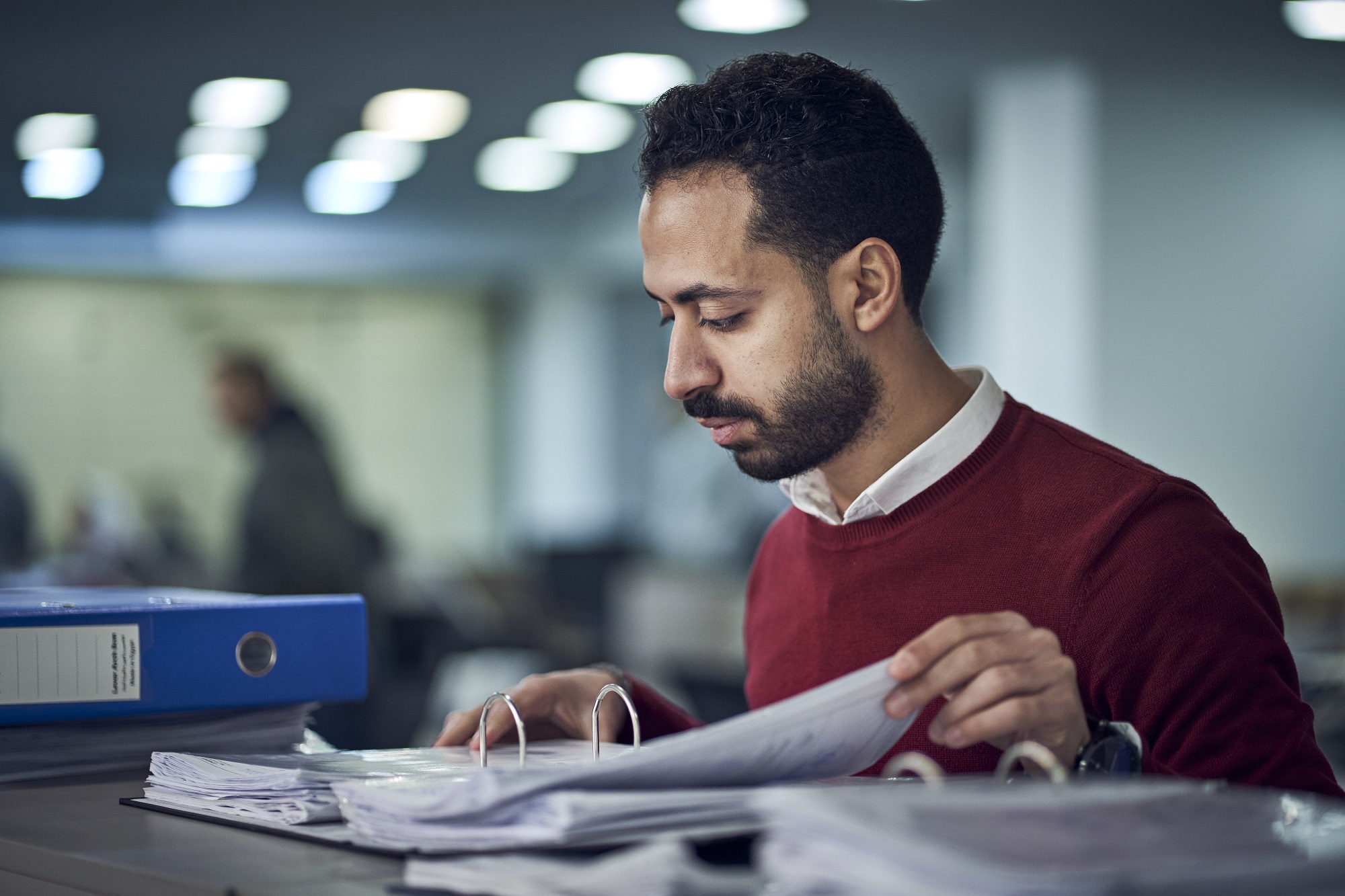 man standing looking at a file
