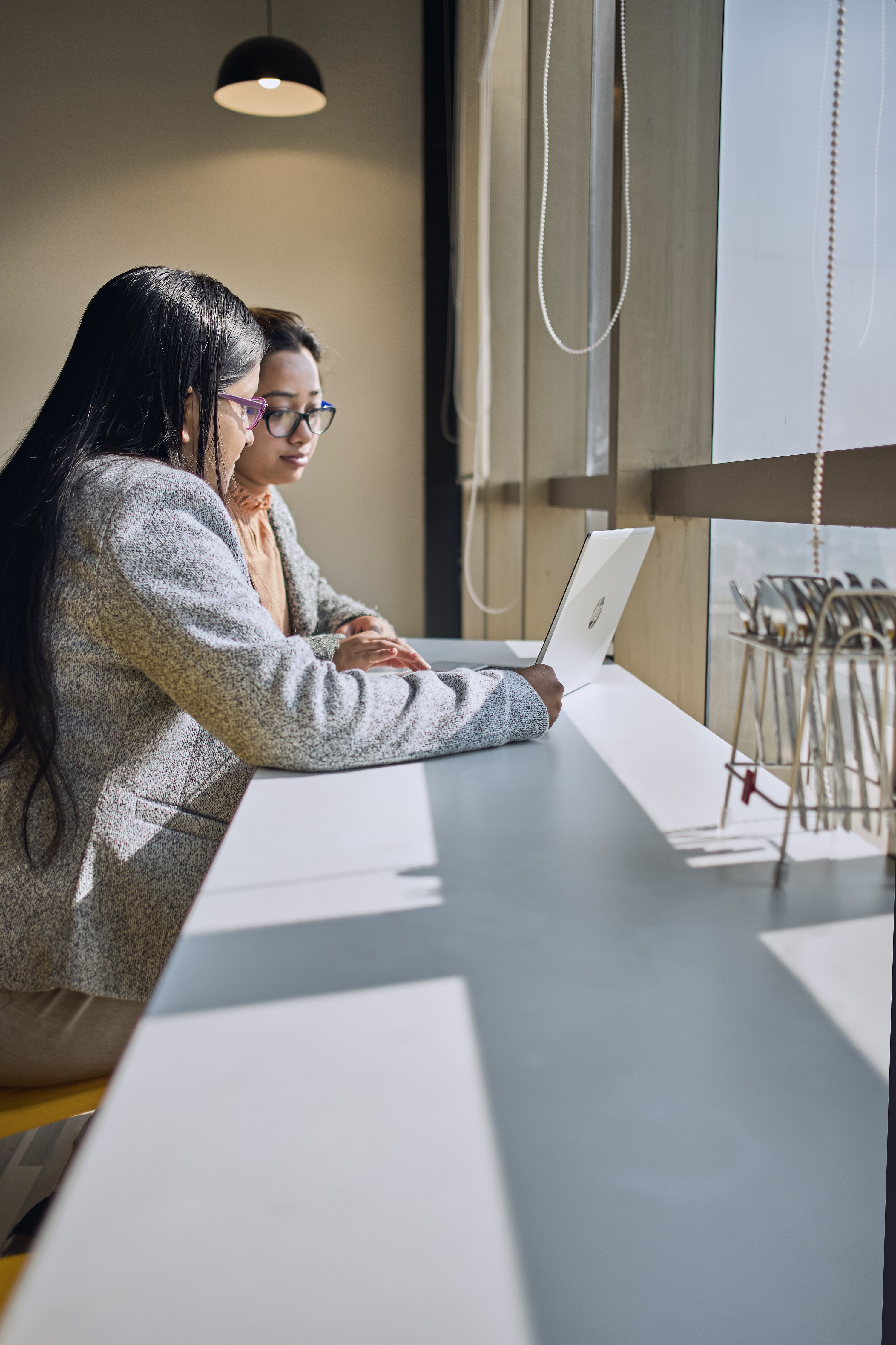 Two women looking at laptop