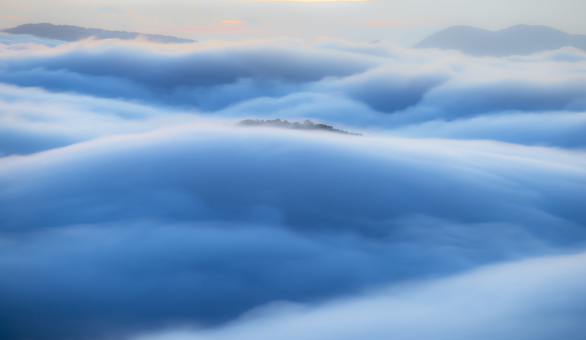 Dance of the wave fog with dramatic light and sky at sunrise