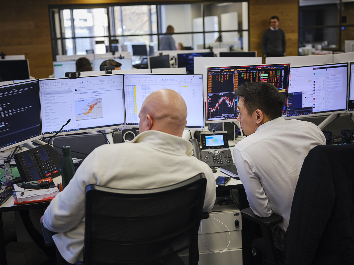 two men discussing work at their computer