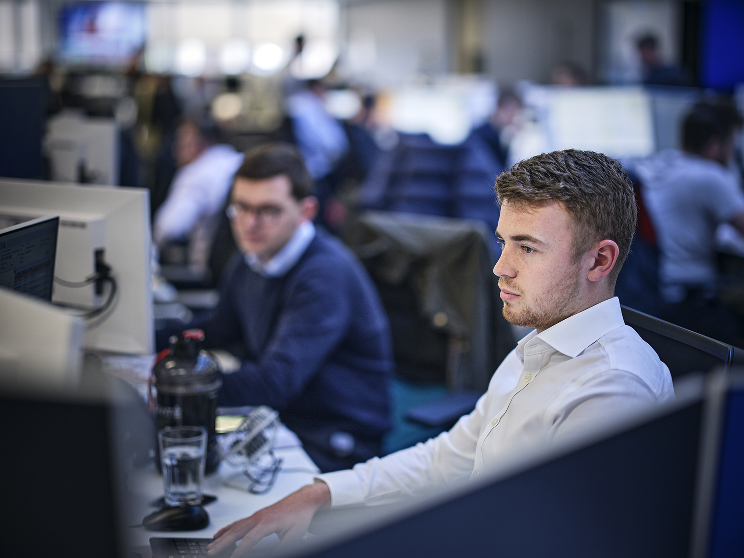 broker in the office at his computer