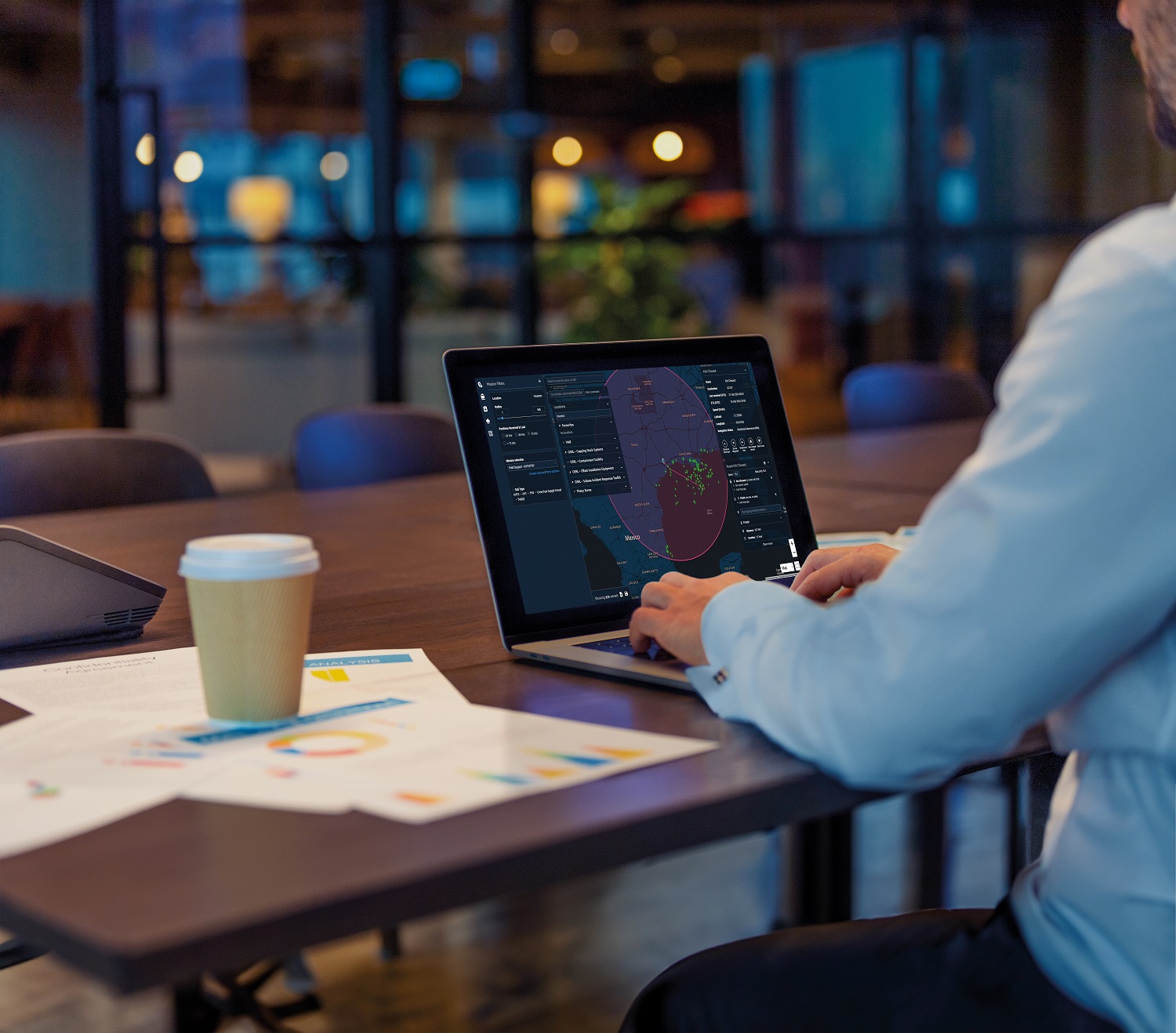 Person working on a laptop at a table.