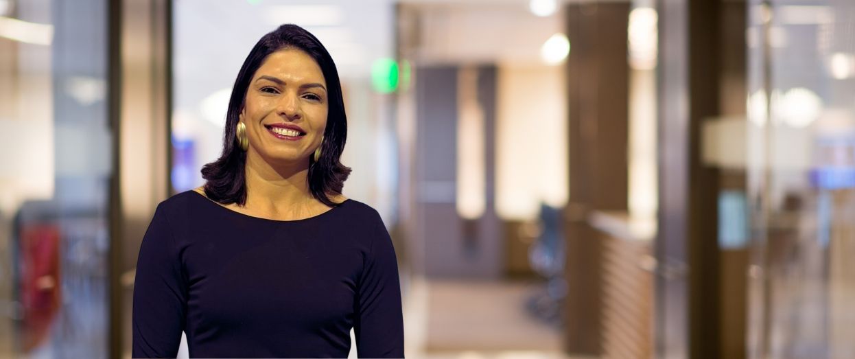 Smiling woman in a professional office setting.