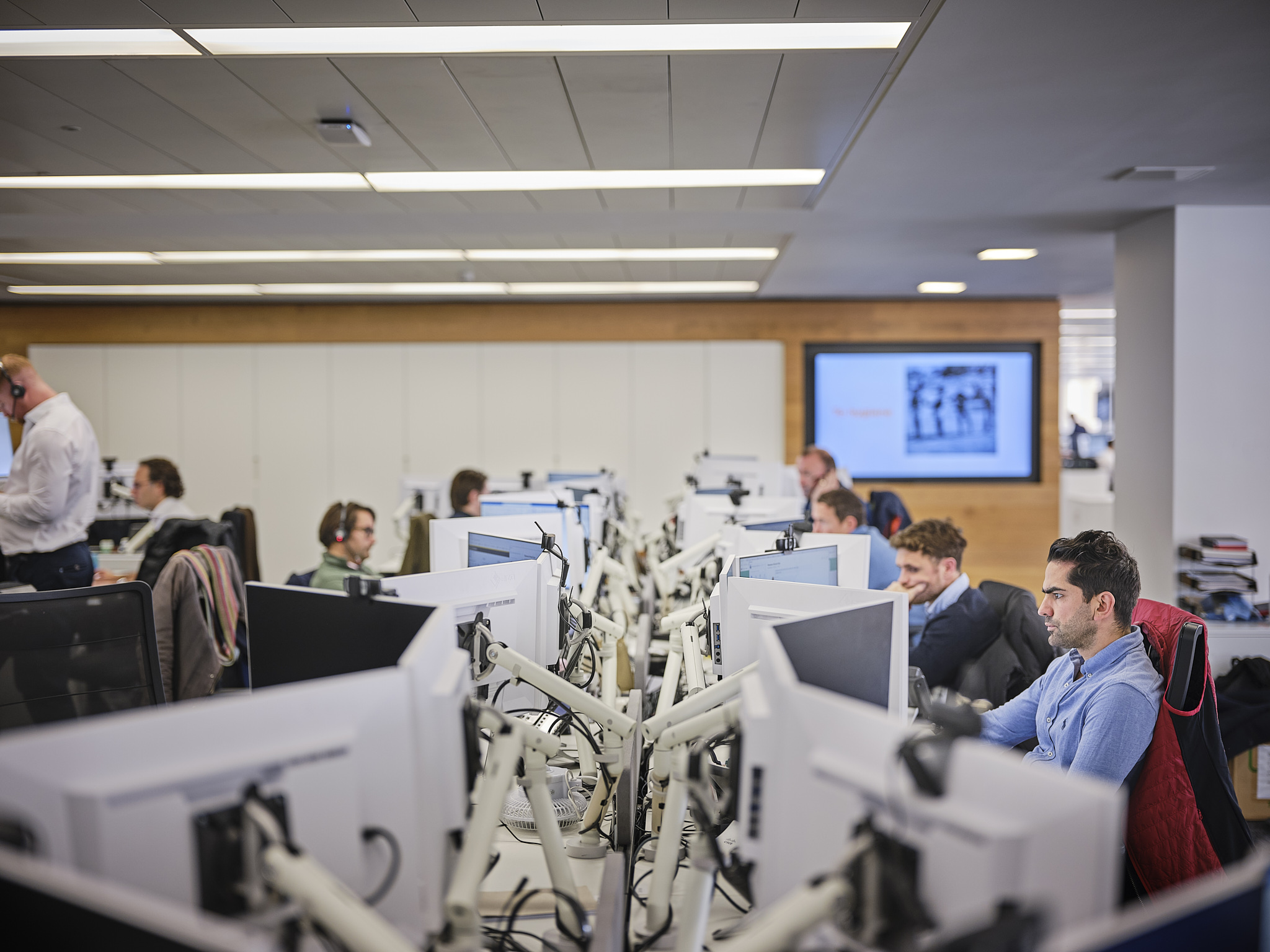 Office workspace with people at desktop computers.