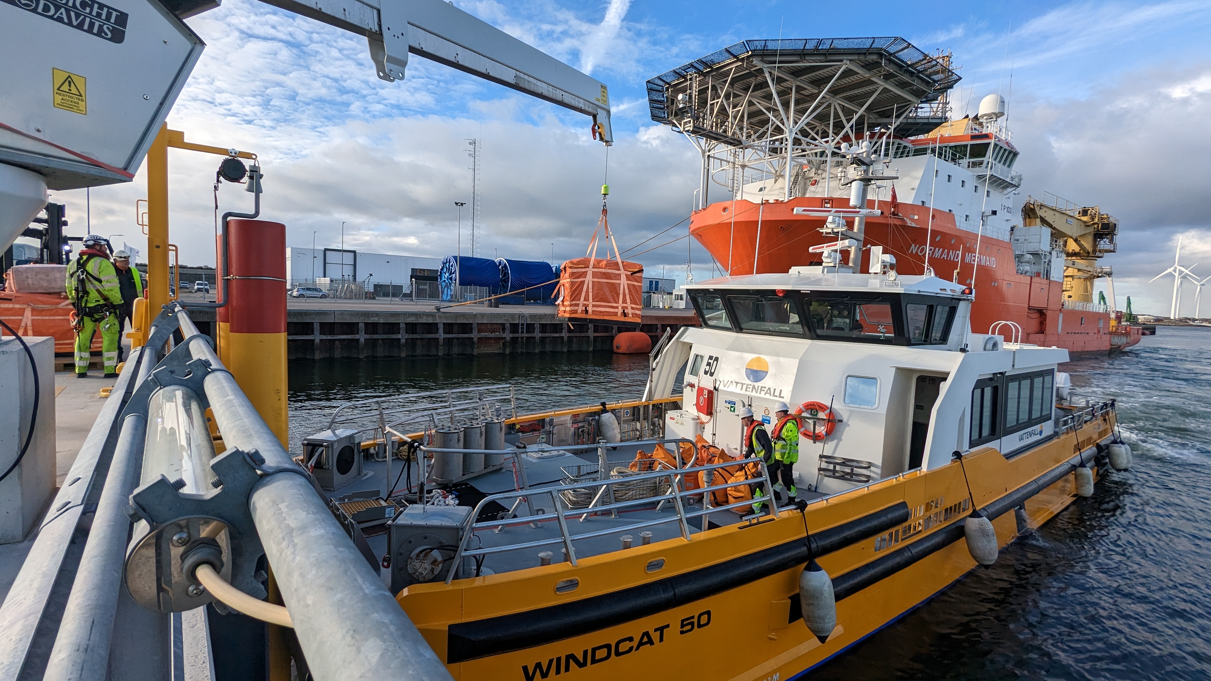 Boat near a large ship in a harbor setting.