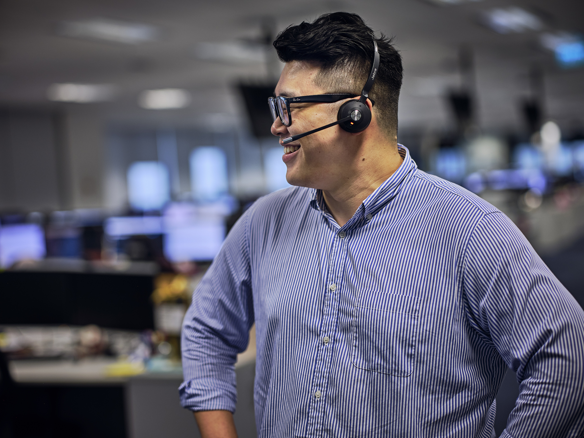 Clarksons broker in Singapore office with headset